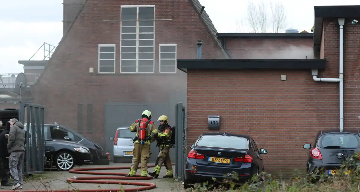 Auto vliegt in spuitcabine in brand