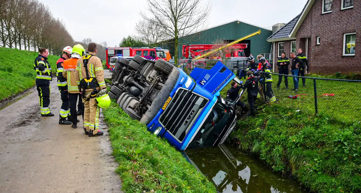 Chauffeur bekneld nadat vrachtwagen in slootkantelt