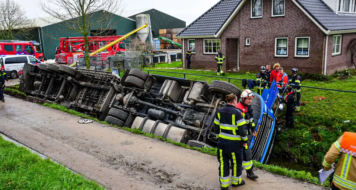 Chauffeur bekneld nadat vrachtwagen in slootkantelt - Foto 7