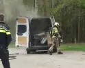 Bestelbus met afval in brand gestoken op parkeerplaats bij bos, twee aanhoudingen