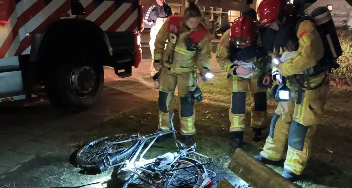 Omstanders blussen brandende fiets - Foto 1