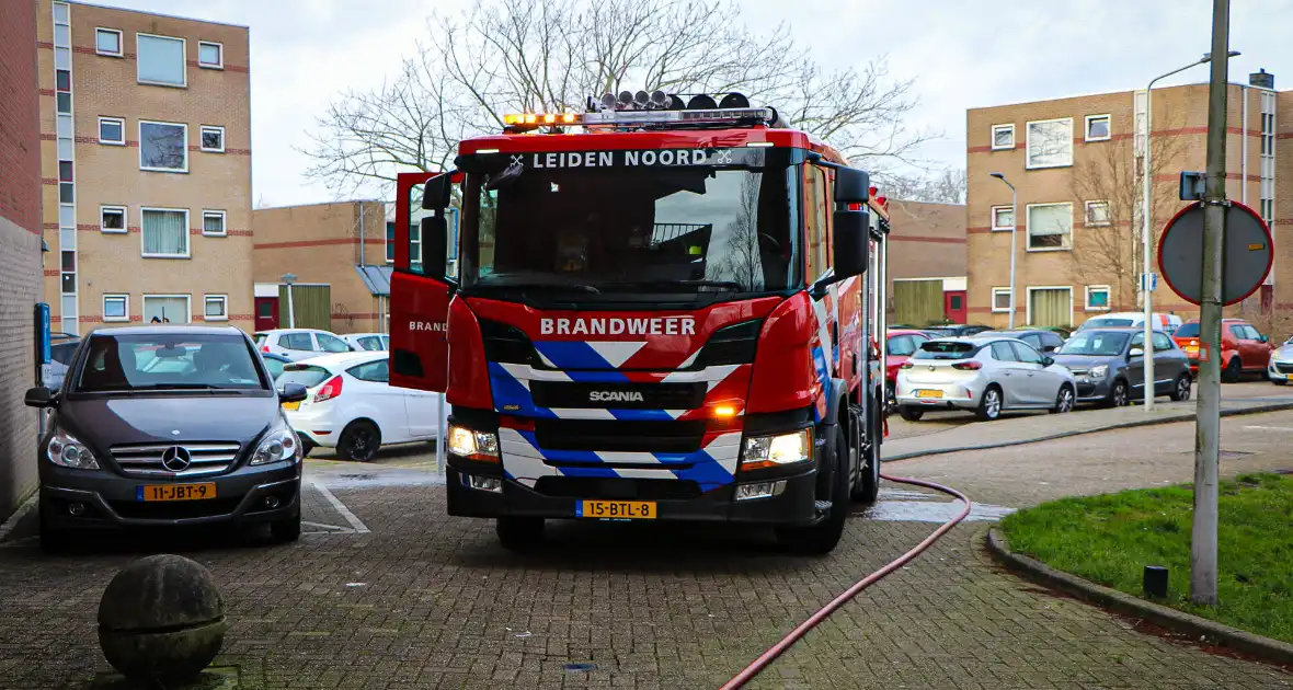 Containers onder flatgebouw in brand - Foto 1