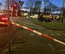 Auto knalt op verkeerslichten en slaat over de kop