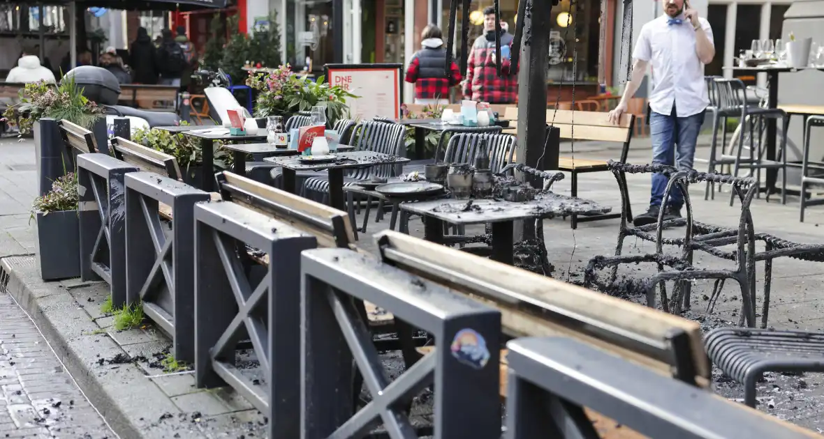 Parasol vat vlam op terras van café - Foto 12