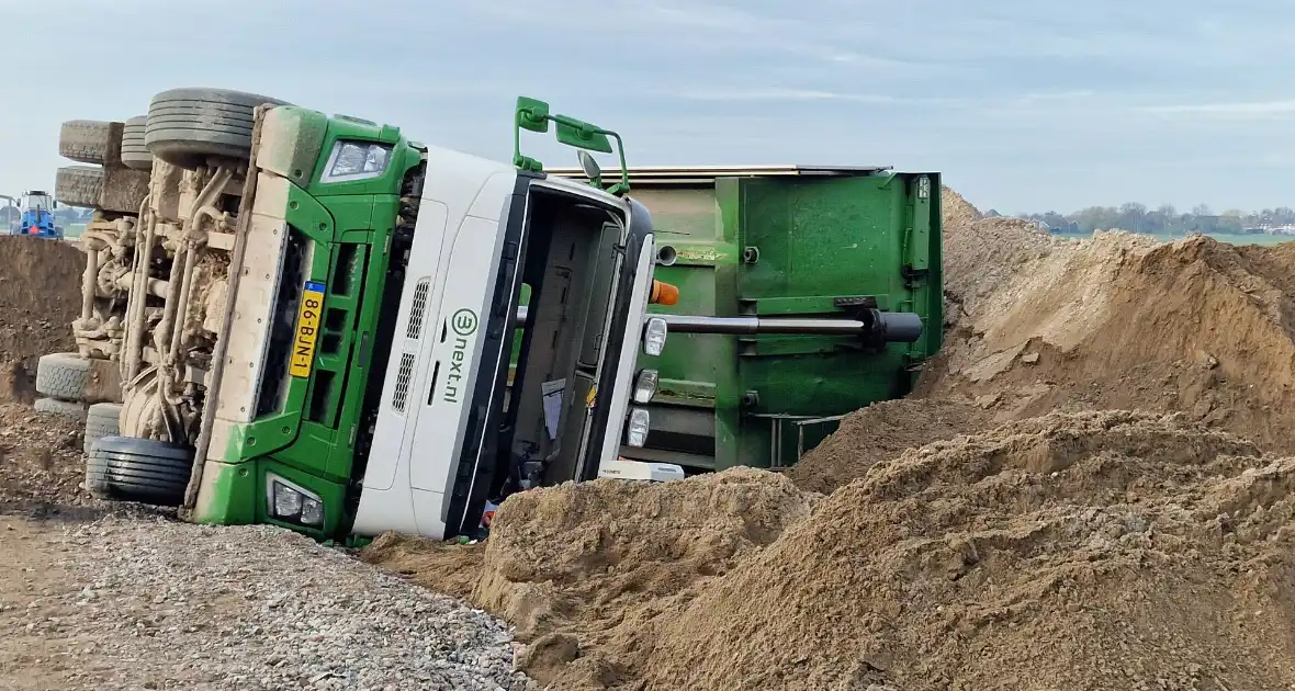 Vrachtwagen kantelt op bouwplaats - Foto 5