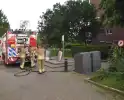 Brand tegen parkeergarage, brandweer aanwezig