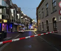 Deur opengebroken vanwege brand in winkelpand