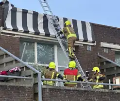 Zonnescherm waait kapot, brandweer ingezet