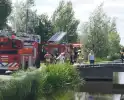 Container in brand tegen woning