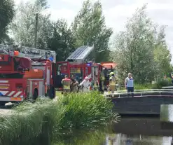 Container in brand tegen woning