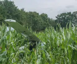 Lesvliegtuig landt in maisveld