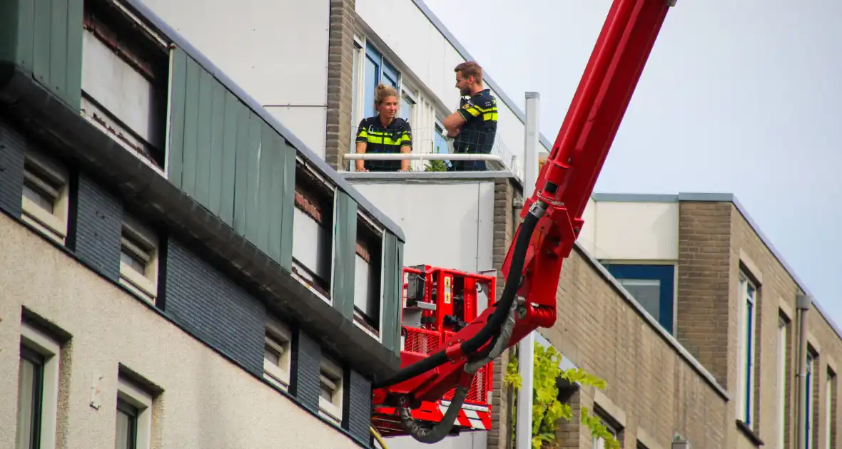 Veel rookontwikkeling bij brand op dak bij portiekwoning - Foto 9