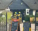 Brand in wasmand vol handdoeken bij restaurant