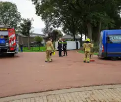 Bestelbus op zijn kant bij aanrijding