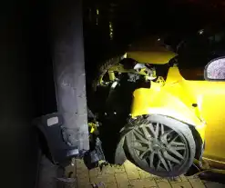 Auto crasht tegen gebouw, inzittenden ongedeerd