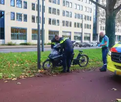 Persoon op bakfiets glijdt onderuit door bladeren op fietspad