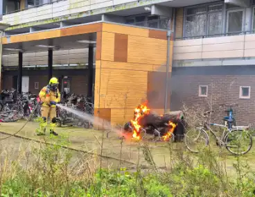 Brandweer blust brandende motor