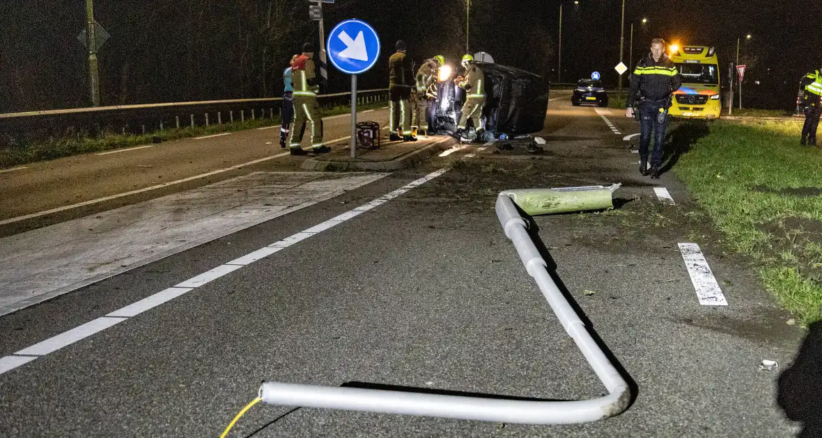 Automobilist ramt lantaarnpaal en belandt op zijkant - Foto 2