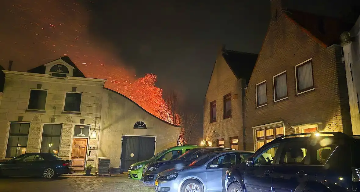 Brandende coniferen haag met tuinslangen geblust - Foto 4