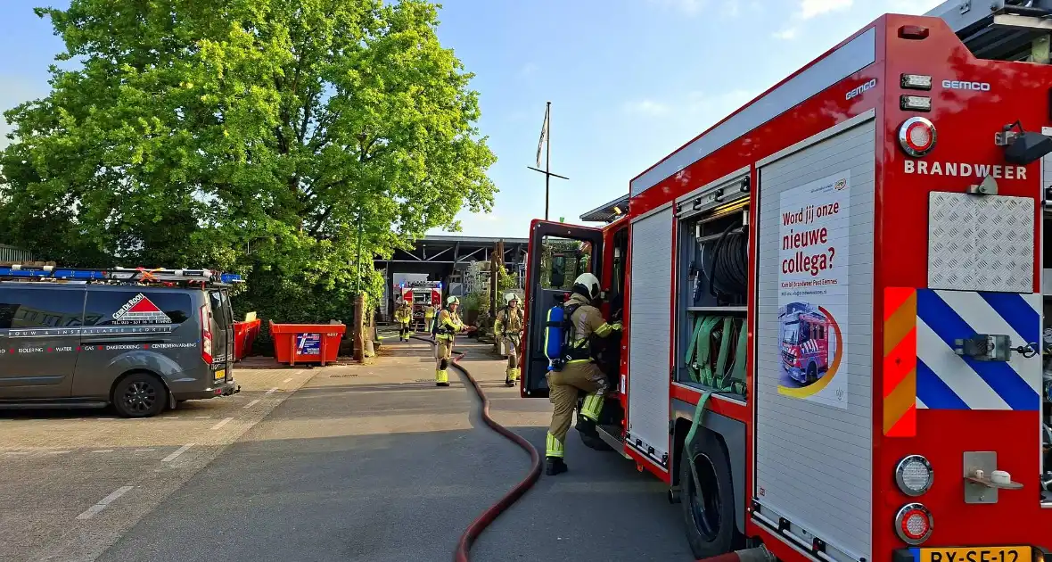 Palletopslag in brand, gebouw bedreigt - Foto 1