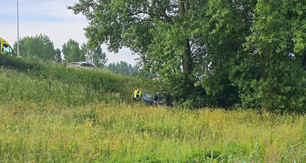Auto rijdt van talud en belandt tegen boom - Foto 5