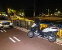 Eenzijdig ongeval met driewielige motorscooter op fietsbrug