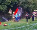 Auto rijdt van dijk af en slaat voorover