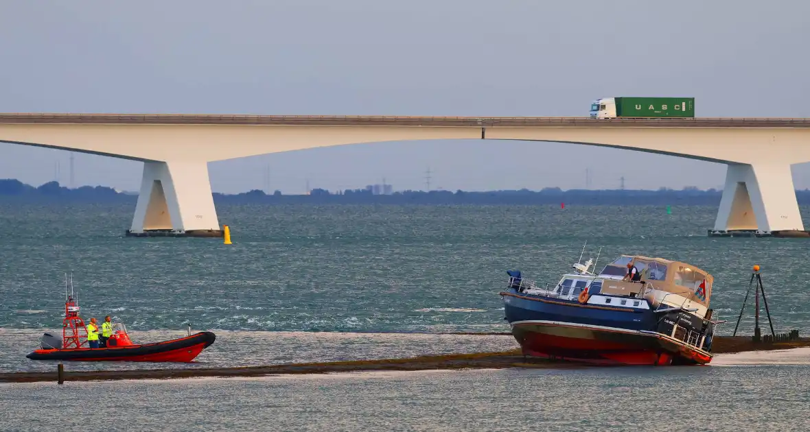 Boot loopt vast op dam, bergingsbedrijf schiet te hulp - Foto 7