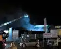 Brandweer groots ingezet bij brand in autobedrijf