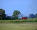 Brand in tractor, brandweer schaalt op wegens waterwinning