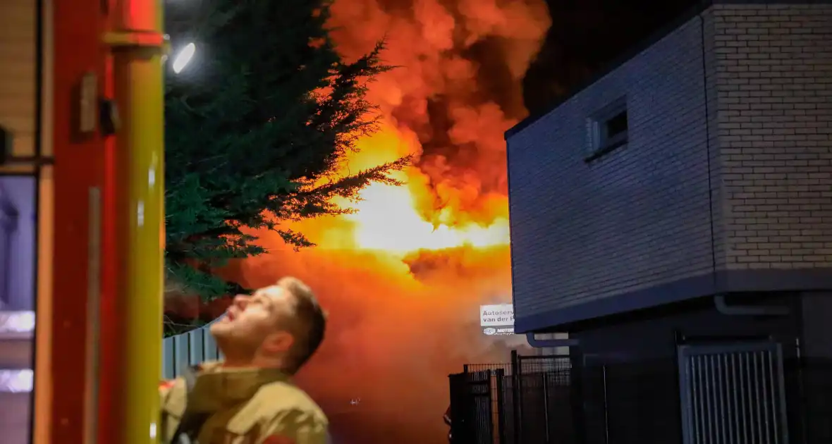 Grote vlammen bij uitslaande brand in garage pand - Foto 2