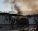 Uitslaande brand in loods transportbedrijf